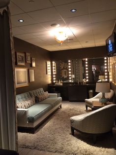 an overhead view of a living room with pictures on the wall and lights in the ceiling