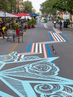 the sidewalk is painted with an artistic pattern