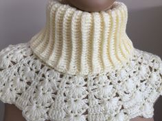 a white crocheted neck scarf on top of a mannequin's head