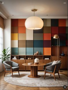 a living room with two chairs and a round table in front of a multicolored wall