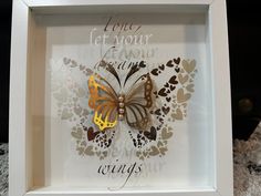 a white frame with a butterfly in it