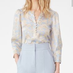 This Silk Charmeuse Top Features Our Satin Leaf Fleur Print, A Floral Pattern In A Spring-Forward Palette Of Sky Blue And Gold. Finished With Full Sleeves And A Half Button Front. Model Is A Size 2. Height 5'10 Hits At Low Hip 25" Inches From High Point Shoulder 100% Silk Silk Blouse With Floral Print, Blue Silk V-neck Blouse, Silk Floral Print Top For Work, Feminine Silk Blouse For Daywear, Elegant Blue Viscose Blouse, Blue Silk Blouse For Fall, Chic Blue Silk Blouse, Formal Silk Blouse For Spring, Formal Blue Floral Print Tops