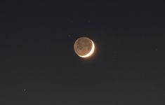 the moon and venus are visible in the night sky