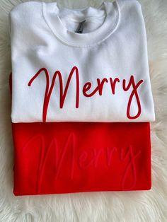 two t - shirts with merry written on them, one red and the other white