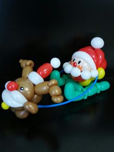 an inflatable santa claus and reindeer on a rope