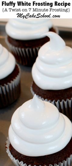 chocolate cupcakes with white frosting sitting on top of a metal tray in front of the words fluffy white frosting recipe