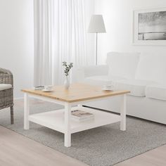 a living room with a white couch and coffee table