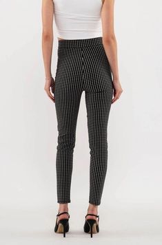 Add modern style to your wardrobe with these checkered-pattern skinny leg pants. Featuring decorative pockets, a snap button and a high waist, these are designed to be both comfortable and flattering. The black and white checkered print adds a urban styling, taking them from work to date night. Small is 28.5" inseam and 28.5" waist. Stretchy, but go up a size if you have bigger hips. Made in China 75% rayon; 22% polyester; 3% spandex Hand wash cold Chic Stretch Plaid Bottoms, Trendy High Waist Houndstooth Bottoms, Chic Houndstooth High-waisted Pants, Chic Stretch Houndstooth Bottoms, Trendy Fitted Houndstooth Bottoms, Chic Fitted Houndstooth Pattern Bottoms, Fitted Black Houndstooth Bottoms, Black Houndstooth Trousers, Trendy Stretch Houndstooth Bottoms