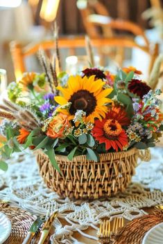 a basket filled with lots of flowers sitting on top of a table next to plates