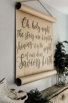 a wooden sign hanging on the wall above a mantle with shoes and potted plants