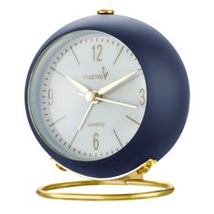 a blue and white alarm clock sitting on top of a metal stand with gold hands