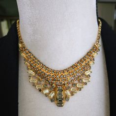 Vintage Rhinestone Bib Necklace Statement Necklace Beautiful Vintage Necklace Is Dimensional And Well Constructed Featuring Pale Yellow And Smokey Gray Rhinestones All Prong Set Into Shiny Gold Tone Metal. Necklace Measures About 15 1/2 Inches From End To End And Is Adjustable Shorter With The Hook Clasp. The Stationary Front Bib Portion Is 1 5/8 Inches Wide At The Center Front. In Excellent Vintage Condition. Designer Quality, But Unsigned. Metal Necklace, Necklace Statement, Hook Clasp, Gray Yellow, Bib Necklace, Pale Yellow, Vintage Rhinestone, Gold Tone Metal, Vintage Necklace