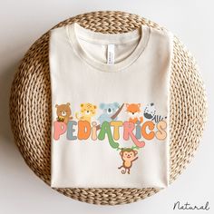 Pediatric Nurse Shirt Crewneck Gift With Animals, Pediatric Shirt, Peds Nurse Shirt Gift, Peds Nurse Crew Shirt, Pediatric Nursing Shirt ❥ DESCRIPTION: This pediatric nurse shirt crewneck gift with animals is unisex, soft, lightweight, with just enough stretch. 100% soft cotton and quality print make users fall in love with it over and over again. This adorable pediatric nurse shirt makes a great peds nurse gift or for anyone working in pediatrics. ❥ BRAND: Bella + Canvas Unisex Jersey T-Shirt (Crewneck) ❥ COLOR: Ash Grey, Black, Dark Heather Grey, Heather Mauve, Heather Peach, Natural, Pink, White ❥ SIZE CHARTS: See the image for sizing measurements. Fit is true to size. It's Unisex so if you prefer a slimmer fit, size down one size. If you prefer a looser fit, go up one size. To ensure t Playful Crew Neck Shirt With Cartoon Print, Novelty Multicolor Cotton T-shirt, Multicolor Novelty Cotton T-shirt, Playful Cotton Shirt With Cartoon Print, Cute Crew Neck Shirt With Cartoon Print, Funny Printed Cotton Shirt, Novelty Printed Cotton Tops, Cotton Crew Neck Shirt With Character Print, Printed Cotton Novelty Tops