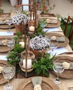 a table set with place settings and candles