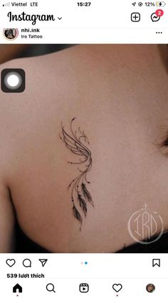 the back of a woman's shoulder with a bird tattoo on her left side