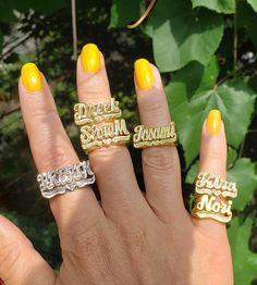 three rings with words on them are shown in front of some green plants and leaves