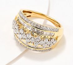 a gold ring with three rows of diamonds