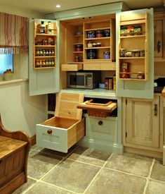 a kitchen with lots of cupboards and drawers