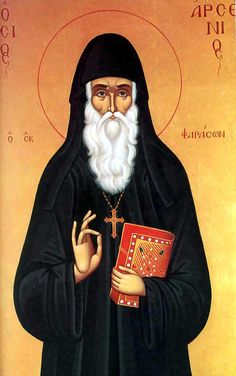 an icon of st nicholas the great holding a red book and wearing a black robe