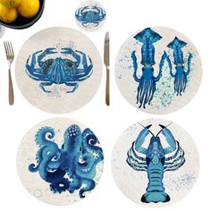 four plates with blue and white designs on them, one has an octopus in the middle