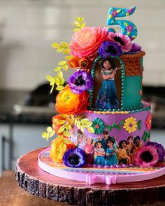 a birthday cake decorated with flowers and the number five on it's tiers