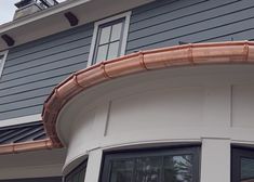 an image of a house with copper gutter on the roof