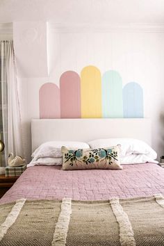 a bedroom with a large bed and colorful headboard