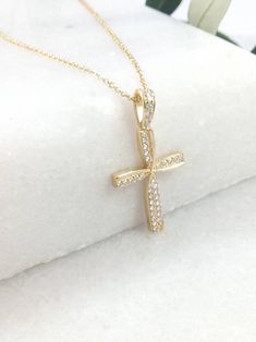 "A fine art cross in K14 made of yellow solid gold. It's decorate with lines of gold that create a very delicate cross in the middle and has small Swarovski stones throughout! A simple, minimal, inter temporal cross. Ideal for a present, engagement gift, anniversary and baptism. It is one of the most beautiful designs and can easily be worn by an adolescent or a woman of any age, who likes minimal design. The dimensions of the cross are: Height 1,26 inches (3,2 cm.) Width 0,67 inches (1,7 cm.) T Swarovski Stones, Gold Cross Pendant, Stone Gold, Sterling Silver Bangles, Gold Cross, 22k Gold, Minimal Design, Engagement Gifts, Cross Pendant