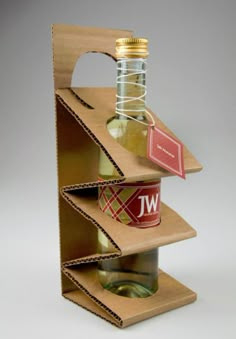 a bottle holder made out of cardboard with wine bottles in the bottom and on top