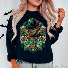 "Elm Street Sweatshirt, Freddy Krueger Sweatshirt, Nightmare Shirt, Horror Movie Shirt, Horror Movie Gift, Halloween Horror Movie Sweatshirt, Halloween Sweater, Halloween Crewneck, Halloween Clothes, Halloween Sweatshirt Women  These sweatshirts are so soft and comfortable! They are perfect to wear this Halloween season!  For an oversized look, order a size or two up from your normal size. Materials: 50% cotton, 50% polyester Medium-heavy fabric (8.0 oz/yd² (271.25 g/m Loose fit Sewn-in label Runs true to size Sizing: These are unisex sweatshirts so they fit a bit looser than women's sweatshirts. Please refer to the size chart image in the listing. I recommend taking one of your favorite sweatshirts and measuring it while it's laying flat. Our size chart measurements are taken while lying Halloween Clothes, Horror Movie Shirts, Colorful Sweatshirt, Halloween Crewneck, Street Sweatshirt, Gildan Sweatshirt, Movie Gift, Halloween Sweater, Movies Outfit