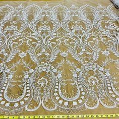 "Introducing our beautiful and luxurious Beaded Lace Fabric Embroidered on 100% Polyester Net Mesh. Perfect for special occasions, this exquisite lace fabric is handcrafted of the highest quality and will shimmer and sparkle in the light. Whether it's a wedding dress, evening dress, quinceanera dress, or dance costume, this beaded lace will add an air of sophistication and elegance. This couture lace features intricate embroidery in multiple colors, making your garment look luxurious and vibrant Ivory Lace Wedding Dress, Scallop Border, Beaded Fabric, Beaded Lace Fabric, Bridal Lace Fabric, Wedding Dress Lace, Embroidered Lace Fabric, Handmade Lace, Wedding Fabric