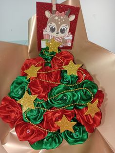 a christmas tree made out of red and green satin material with gold stars on it