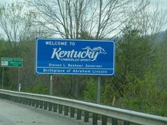 a welcome sign to kentucky on the highway