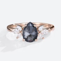 a black diamond ring with three white diamonds