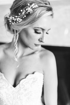 a woman in a wedding dress is wearing a bridal headpiece with pearls on it