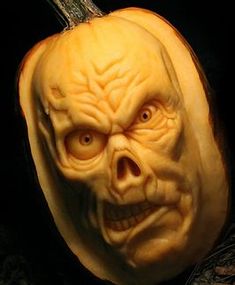 a carved pumpkin with an evil face on it