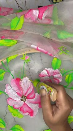 someone is painting flowers on the fabric with acrylic paint and spray it off