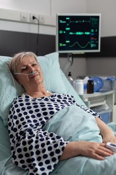 an older woman laying in a hospital bed