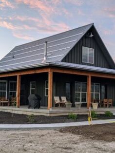 a large black house with a metal roof