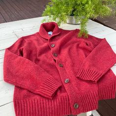 Dusty Red Color Button Up Cardigan With Shawl Like Collar In Poly/ Wool Blend Red Button-up Winter Sweater, Red Button-up Cardigan For Winter, Red Buttoned Sweater For Winter, Red Sweater With Buttons For Winter, Red Winter Sweater With Buttons, Red Wool Cardigan For Fall, Red Winter Sweater With Button Closure, Red Sweater With Button Closure For Fall, Casual Red Sweater With Buttons