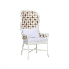 an upholstered chair with white and gold accents