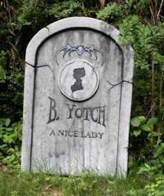 a grave with the name b yotch on it in front of some bushes and trees