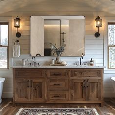 a bathroom with two sinks, mirrors and a rug in front of the bathtub