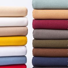 several folded sheets stacked on top of each other in different colors and sizes, with the word