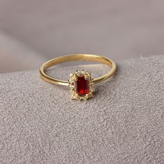 It is a stone that represents passion, true friendship, loyalty, success and consistency. It has names such as dreaming, garnet and mercy stone.. Our rectangular garnet stone ring surrounded by real diamonds will add elegance to your hands. It is a ring that you can use both on special occasions and in daily life. It is a beautiful and stylish product that you can gift to yourself and your loved ones. The color of those born in January is Garnet. Our necklace compatible with our ring; https://qu Cubic Zirconia Jewelry For Christmas Anniversary, Christmas Anniversary Jewelry With Cubic Zirconia, Christmas Anniversary Cubic Zirconia Jewelry, Elegant White Gold Jewelry For Christmas, Elegant Gold Cluster Ring With Emerald Cut, Elegant Ruby Wedding Ring With Halo, Elegant Christmas Diamond Jewelry, Formal Ruby Halo Design Jewelry, Elegant Christmas Celebration Jewelry