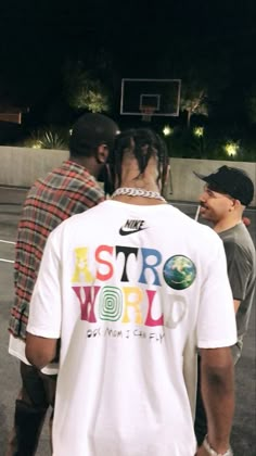 two men standing next to each other on a basketball court with the words astro world written on it