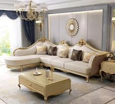 an elegant living room with gold furniture and chandelier