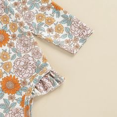 Make a statement at the beach with our Long Sleeve Printed Ruffle Swimsuit! This swimsuit features a unique and eye-catching print, and the ruffle detail adds a feminine touch. Made with a comfortable cotton material, it is perfect for all-day wear. The long sleeves provide extra coverage, making it a great option for those sunny but breezy days. Whether you're lounging by the pool or taking a dip in the ocean, this swimsuit will have you looking and feeling your best. Don't sacrifice style for Spring Long Sleeve Ruffled Onesie, Playful Stretch Onesie For Spring, Long Sleeve Printed Onesie For Summer, Summer Long Sleeve Printed Onesie, Fitted Cotton Bodysuit With Ruffles, Fitted Cotton Ruffle Bodysuit, Long Sleeve Printed Summer Onesie, Fitted Long Sleeve Onesie With Ruffles, Fitted Long-sleeved Onesie With Ruffles