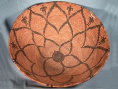 an old woven basket with designs on it