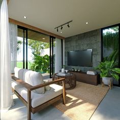 a living room with couches, television and plants in the window sill area